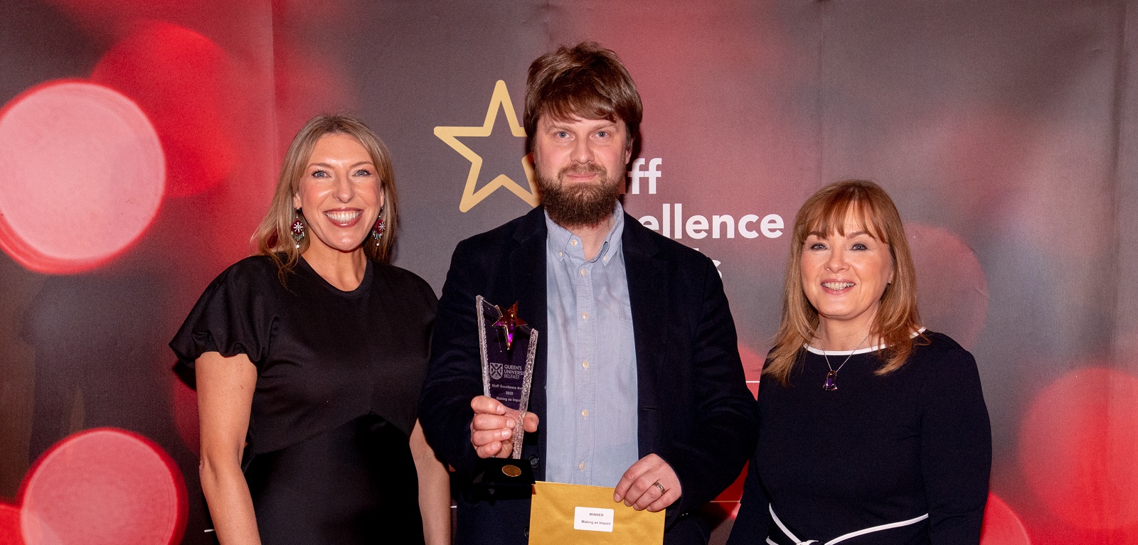 Neil Galway - Making an Impact Award winner (centre), with compere Alexandra Ford and Mairead Regan, Chair of the Staff Excellence Awards Judging Panel